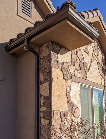 A house with a stone wall and a window