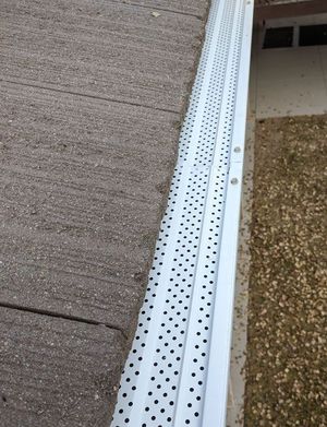 A close up of a white gutter on a roof