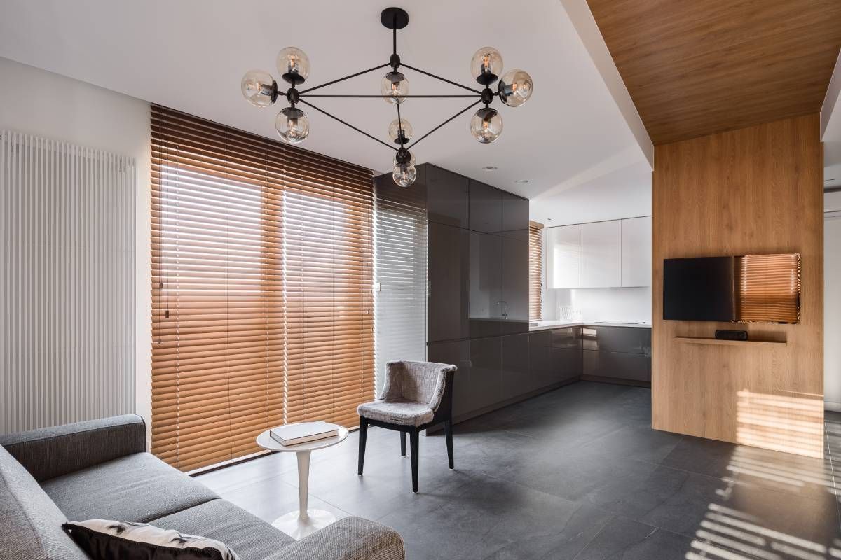 Wood blinds covering windows in a modern living room near Spicewood, TX