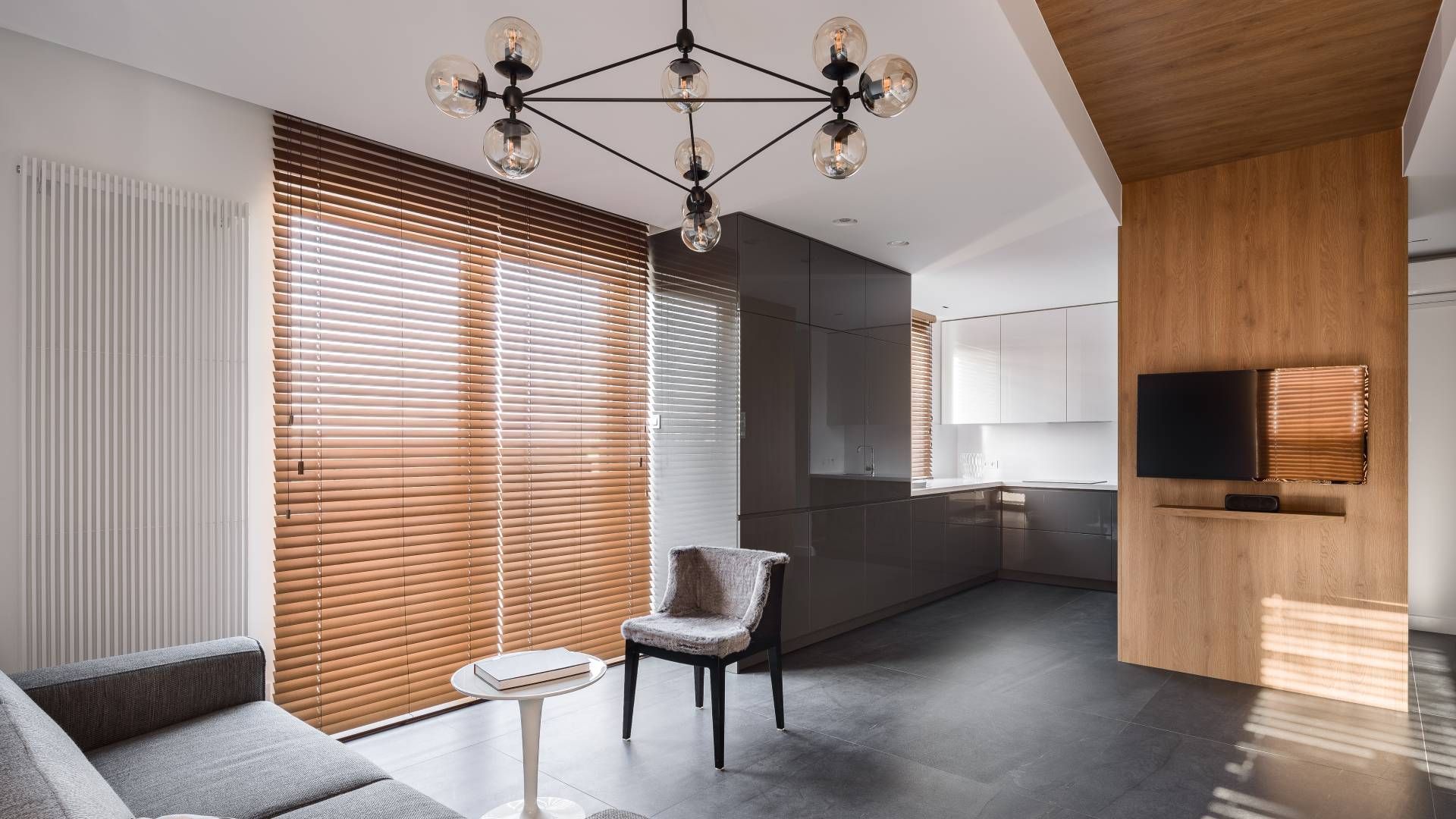 Wood blinds covering windows in a modern living room near Spicewood, TX