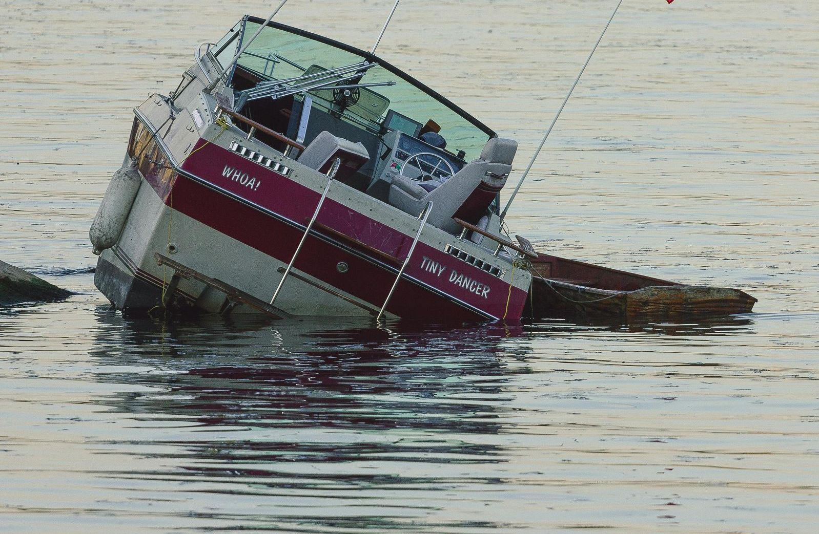 A boat that is floating in the water and has the name steve on it