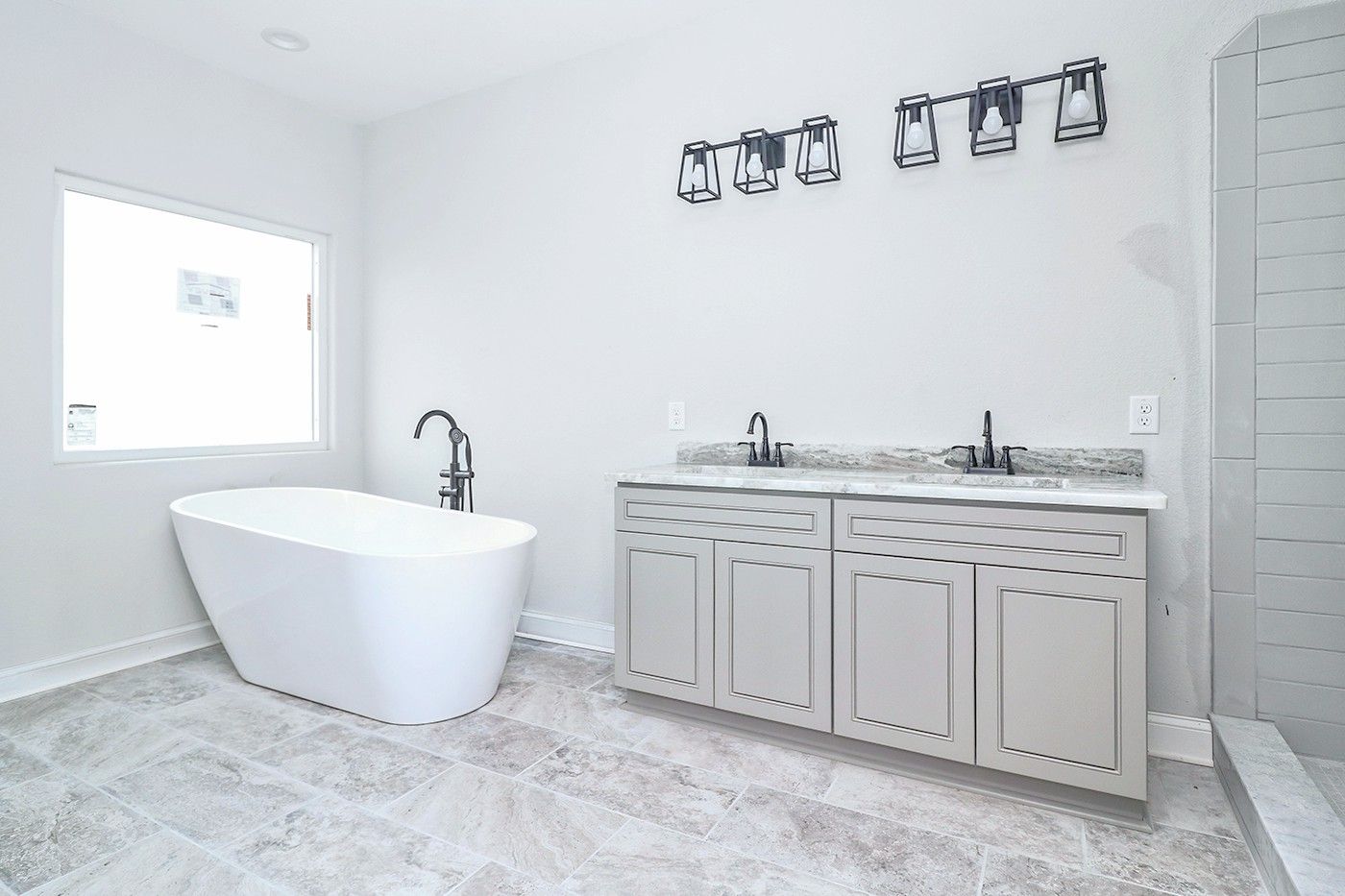 A bathroom with a bathtub , sink , and shower.