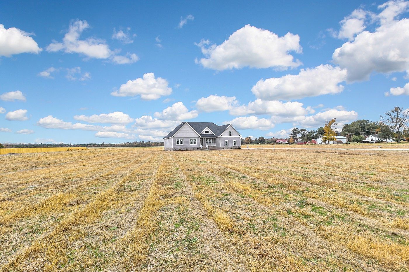 There is a house in the middle of a field.