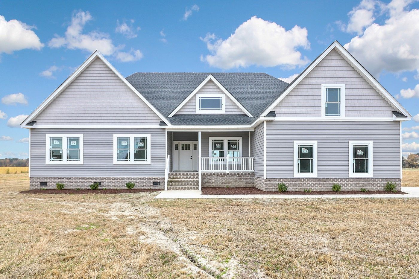 A large house is sitting in the middle of a field.