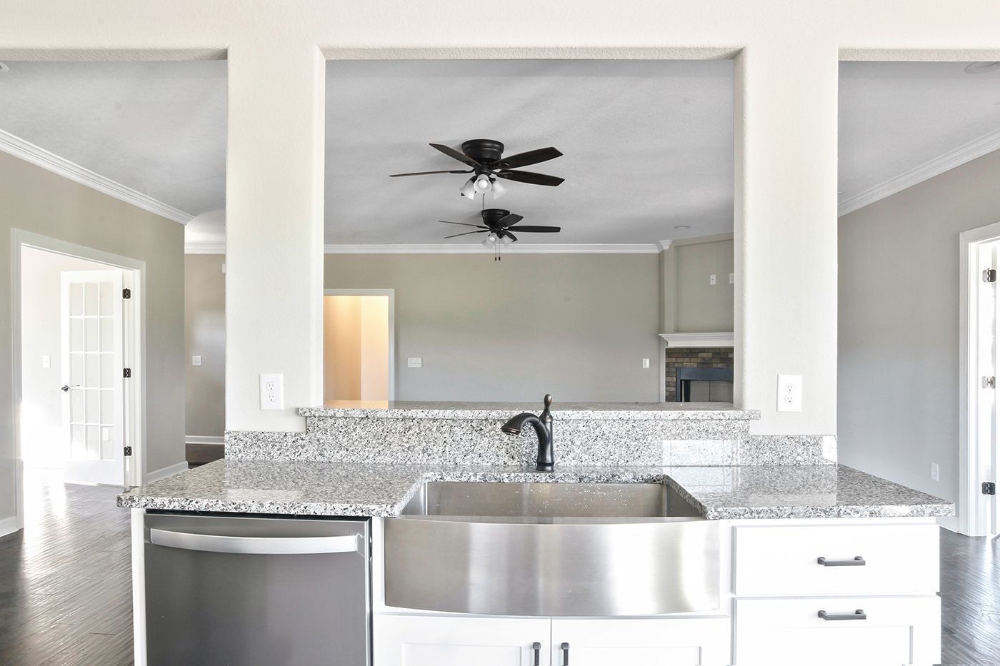A kitchen with a sink , dishwasher , and ceiling fan.