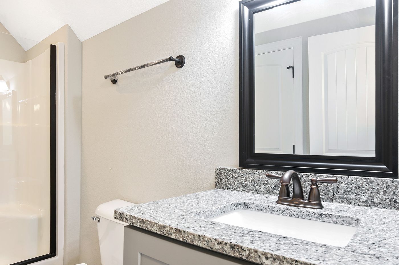 A bathroom with a sink , mirror and toilet.