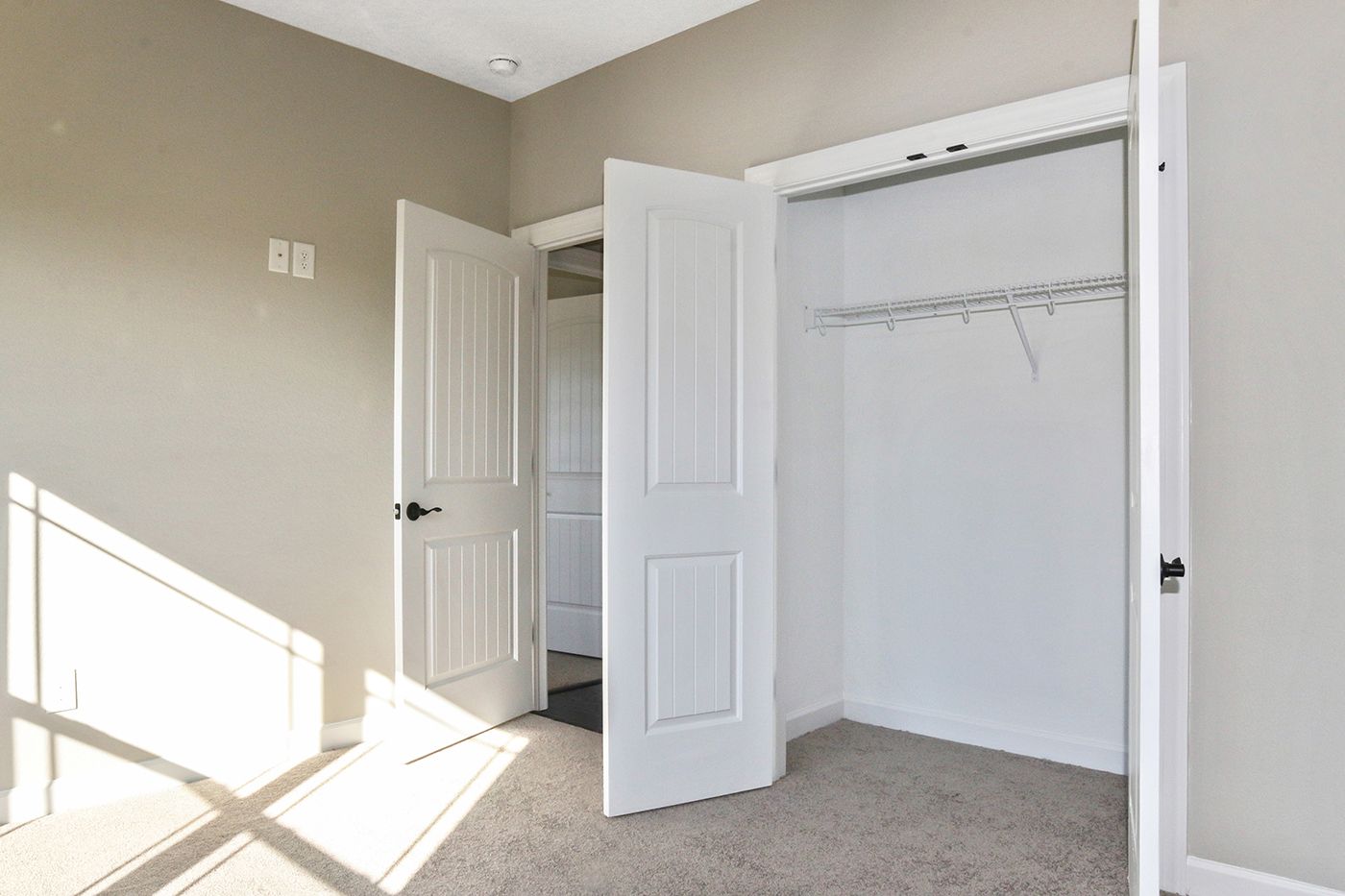 There is a closet in the middle of the room with the doors open.