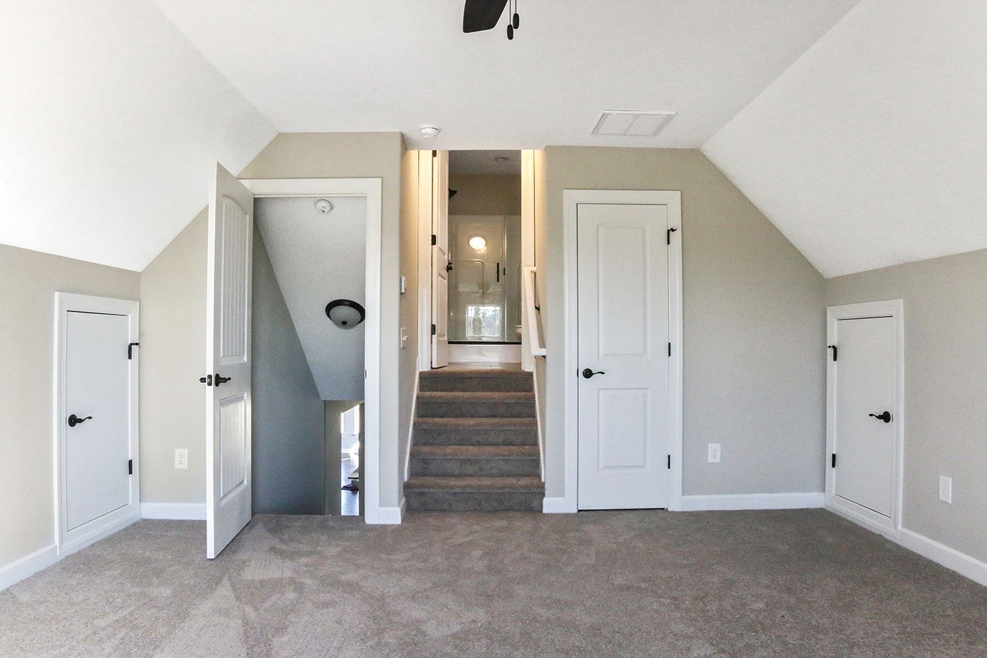 An empty room with stairs leading up to the second floor
