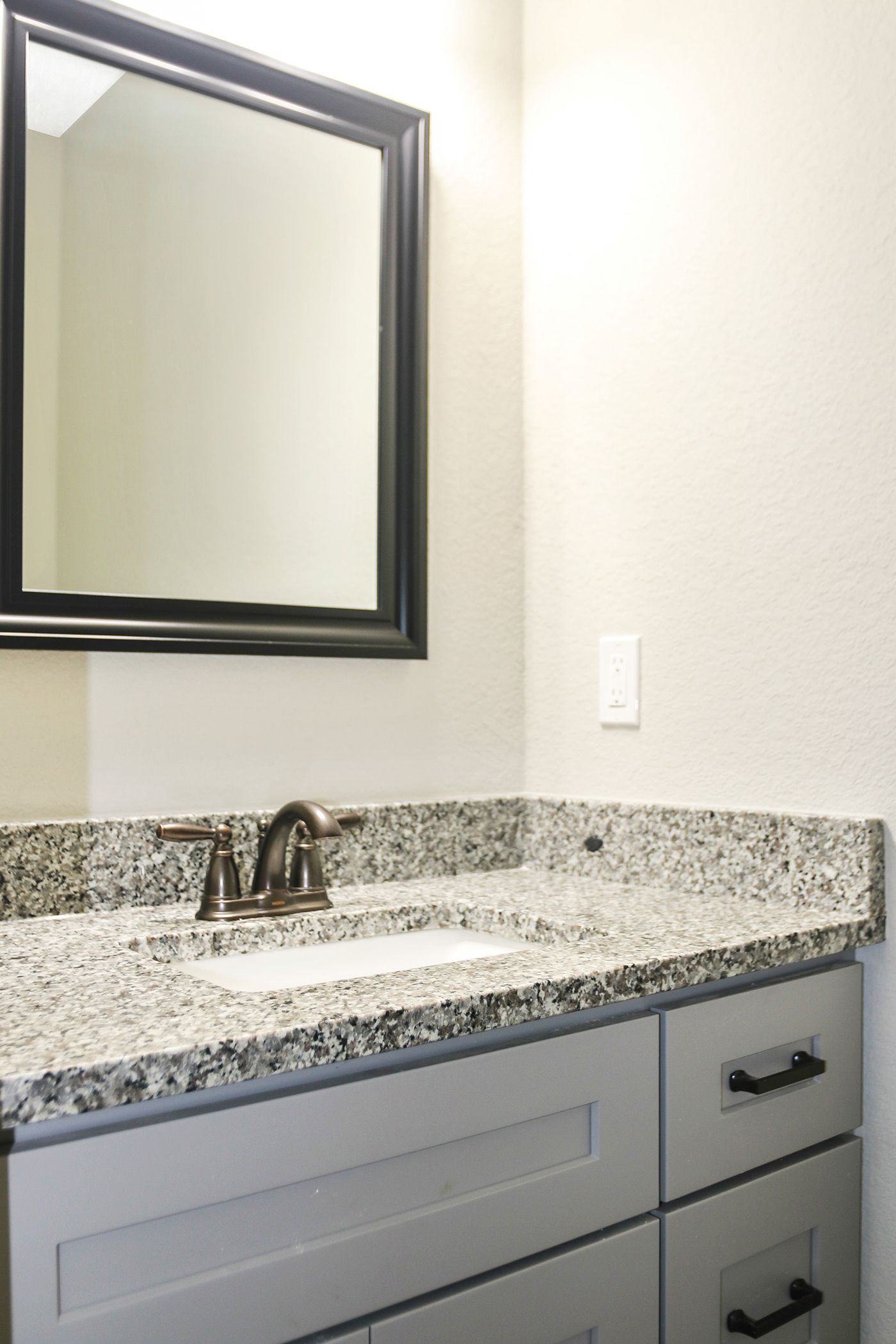 A bathroom vanity with a sink and a mirror