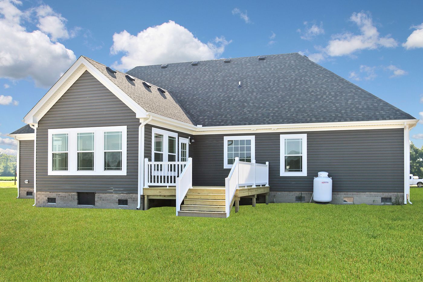The back of a house with a deck and stairs.