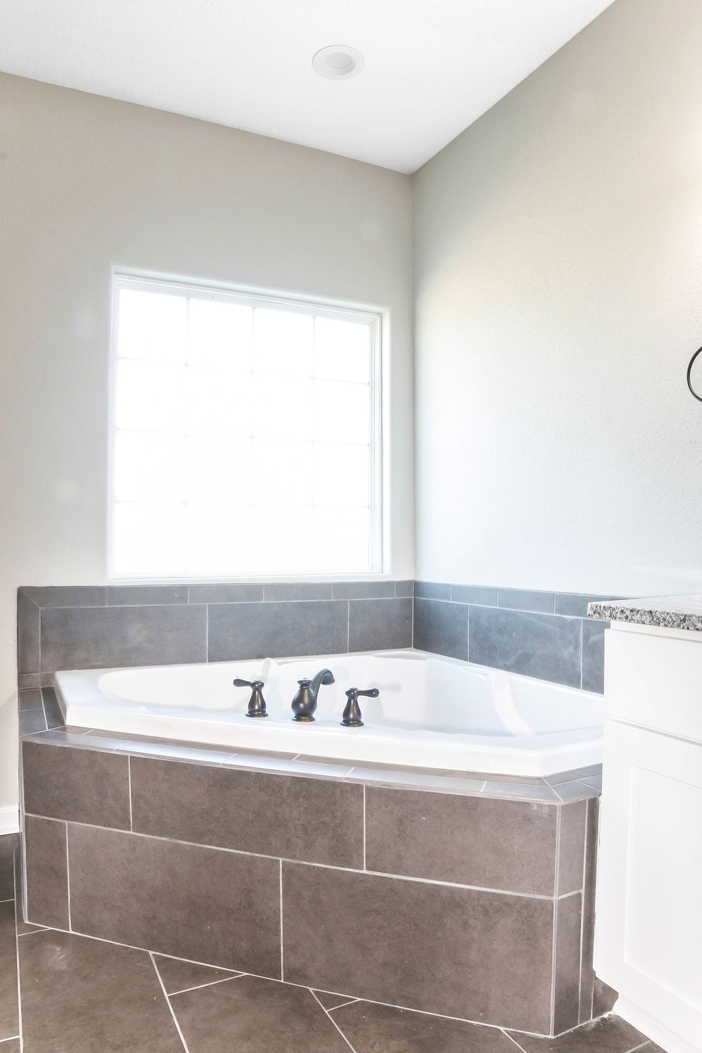 A bathroom with a jacuzzi tub and a window