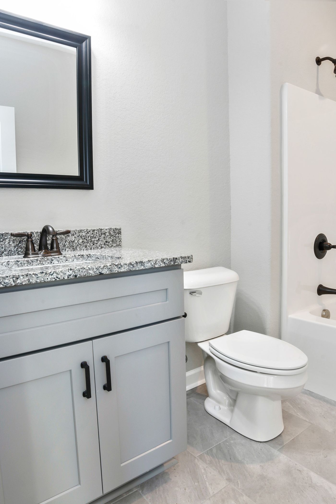 A bathroom with a toilet a sink and a mirror