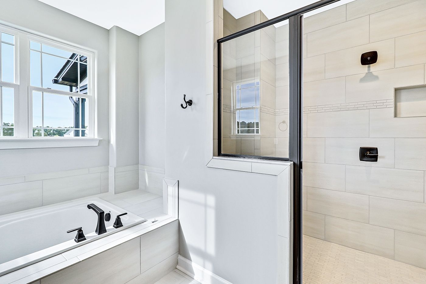 A bathroom with a tub and a walk in shower.
