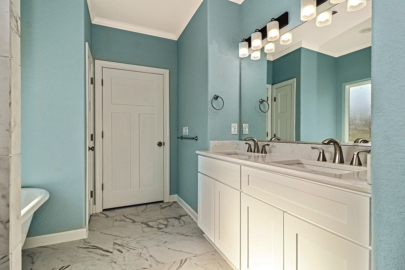 A bathroom with two sinks and a large mirror