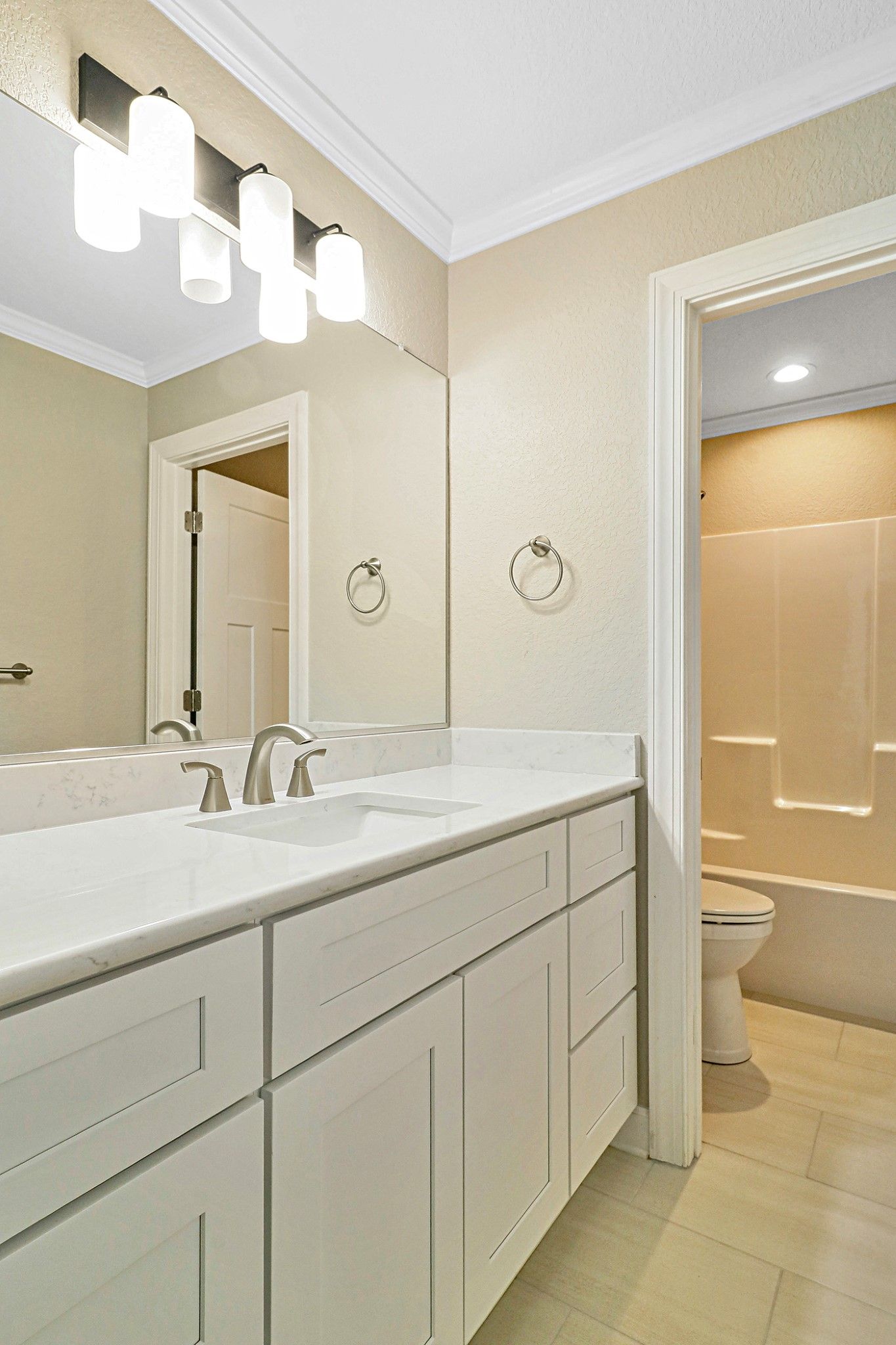 A bathroom with two sinks , a toilet , and a mirror.