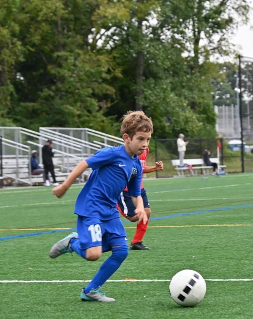 A youth soccer player from  BRYC Academy dribbling the ball
