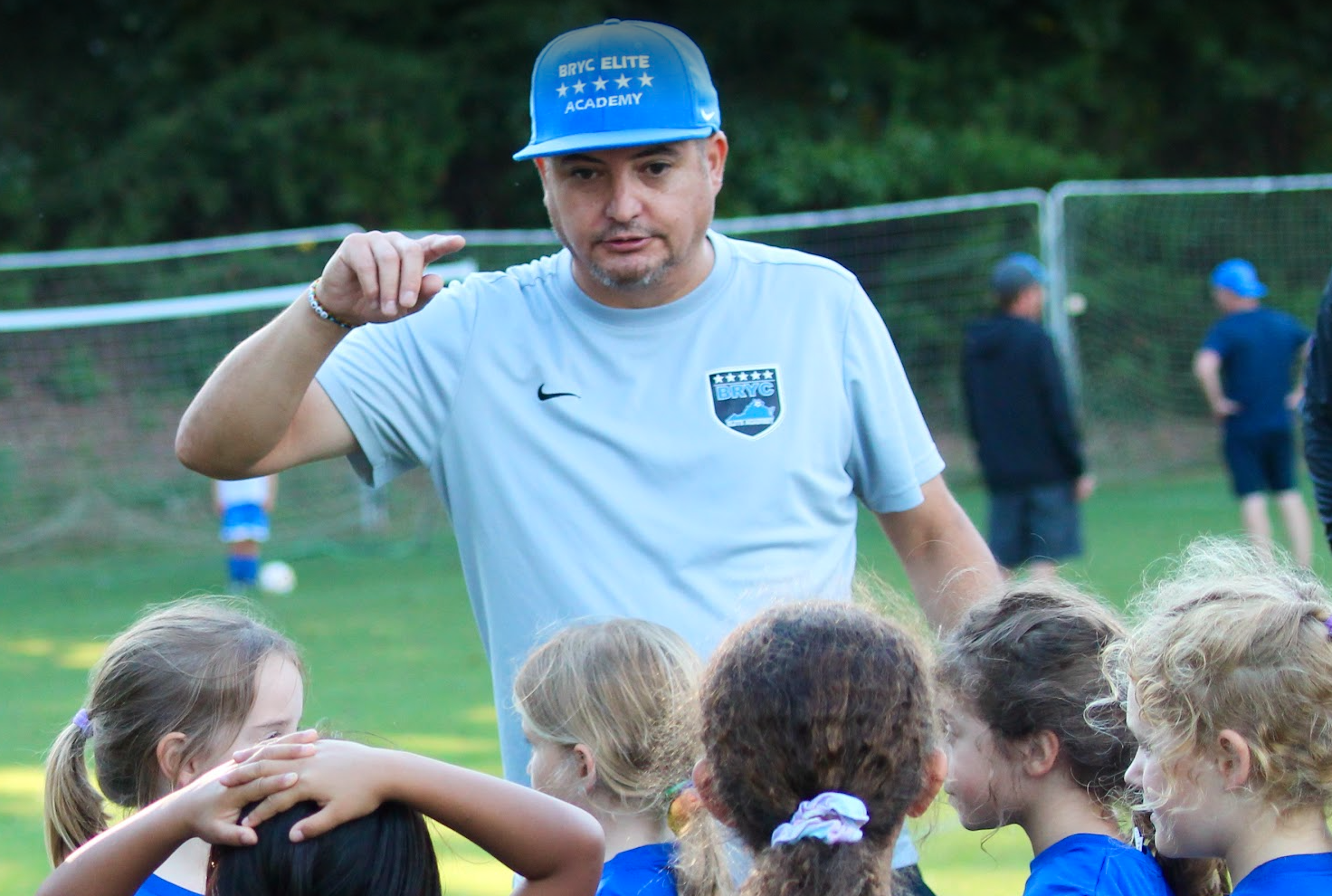 A coach from BRYC Academy talking to his team