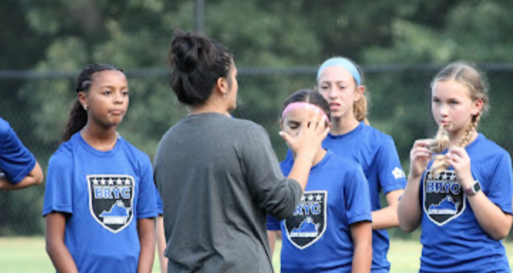 A coach from BRYC Academy talking to his team