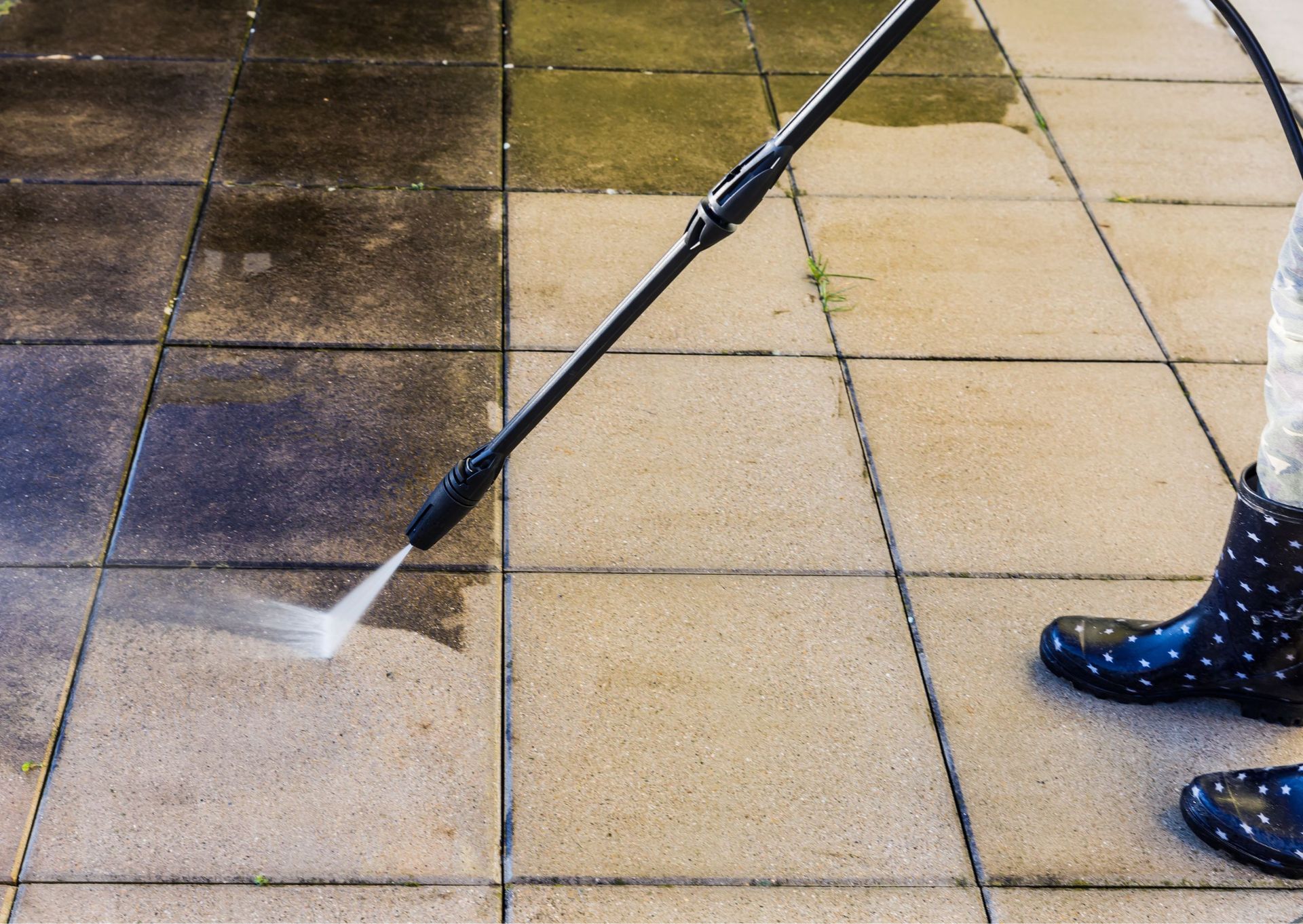 A man is cleaning a window with a squeegee.