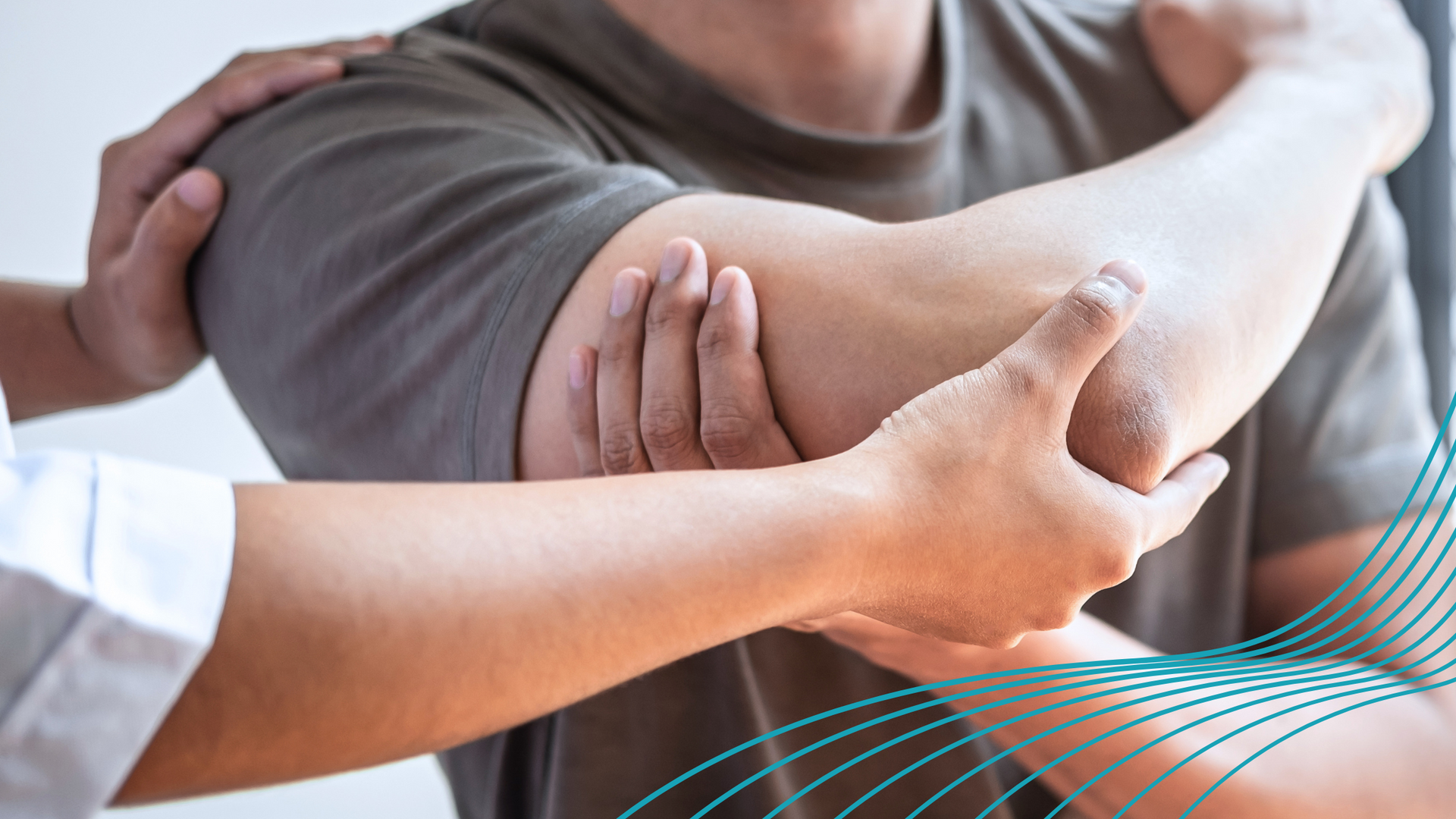 Person's arm being examined by another person's hands for pain or injury.