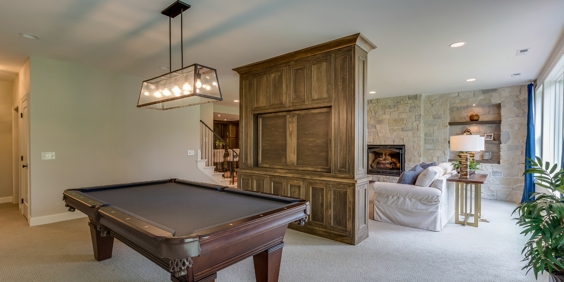 There is a pool table in the middle of the room.