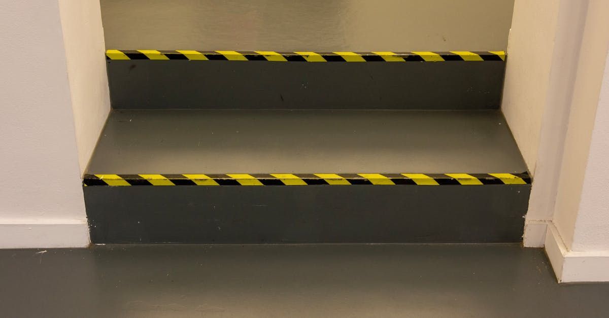 A set of stairs with yellow and black stripes on the steps.