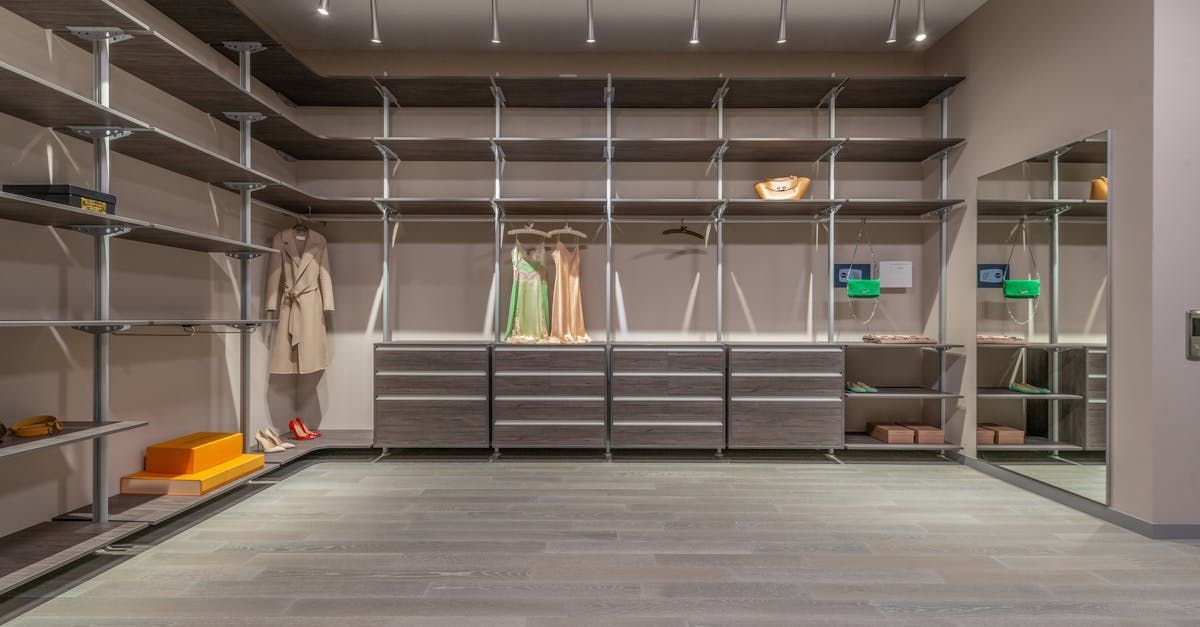 A walk in closet with lots of shelves and drawers and a mirror.