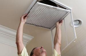 Man Replacing Air Vent Filter — Fresno, CA — Art Douglas Plumbing Inc.