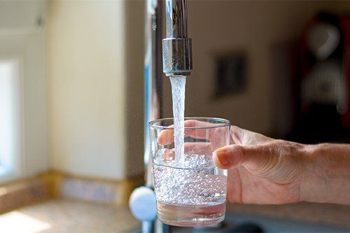 Filling Glass Of Water From Tap — Fresno, CA — Art Douglas Plumbing Inc.