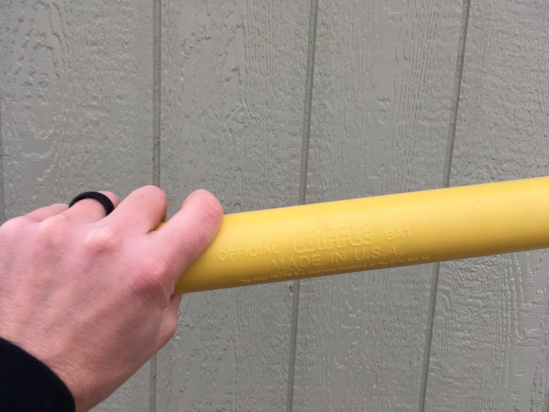 A person is holding a yellow pipe in their hand.