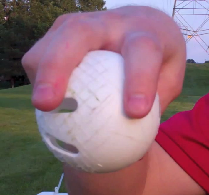 A two finger grip of a wiffle ball