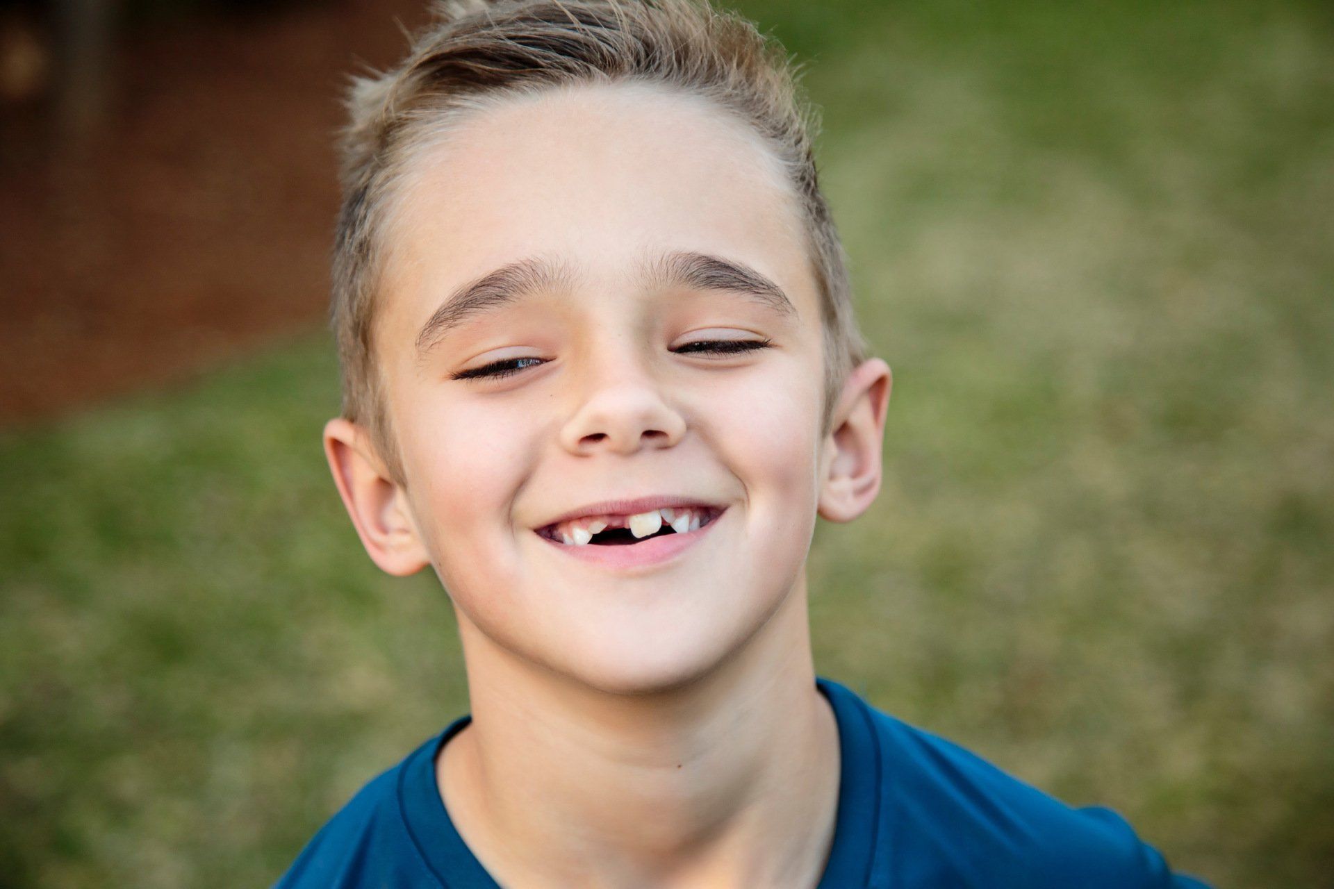Child smiling with missing teeth