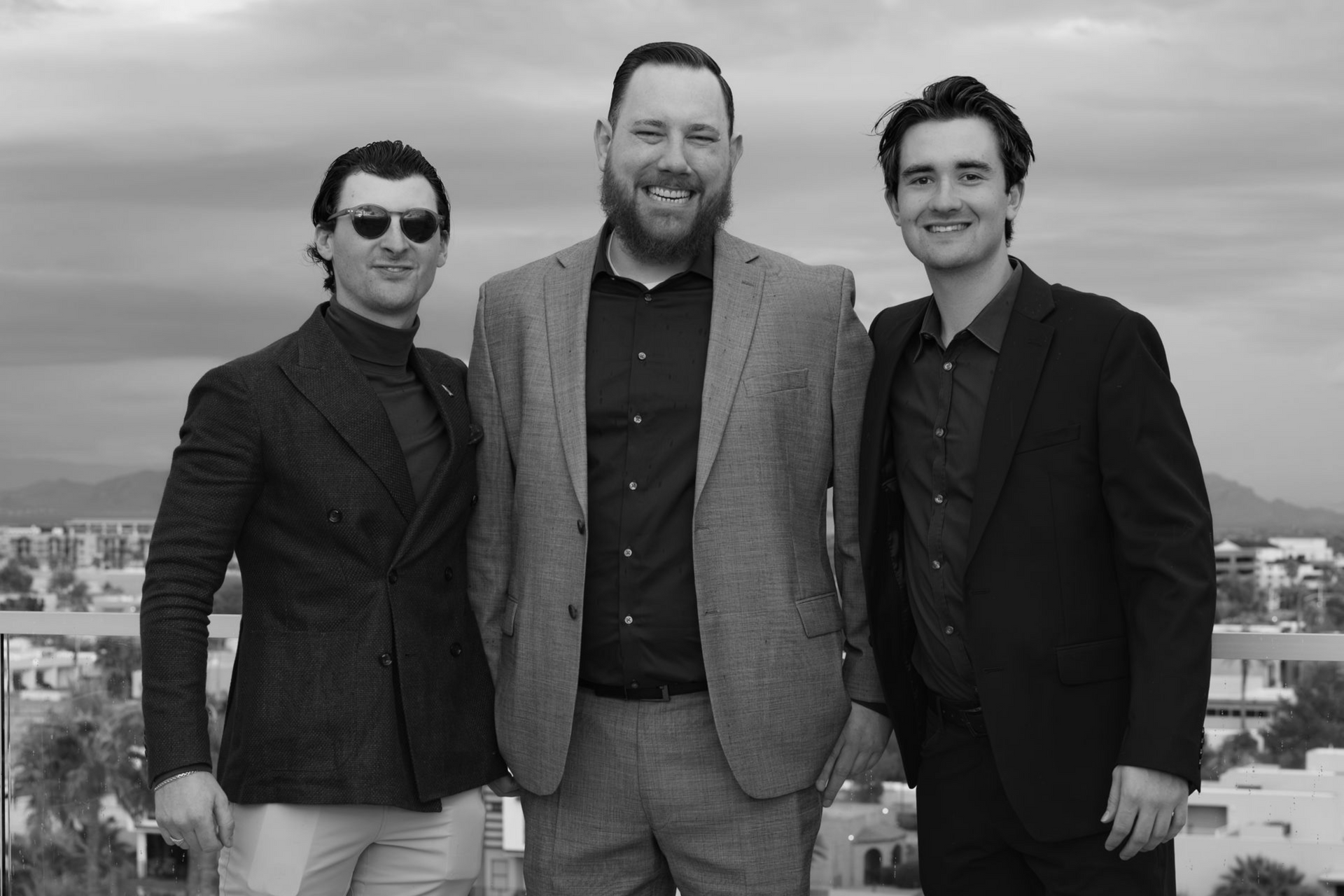 A black and white photo of a group of people sitting in office chairs.