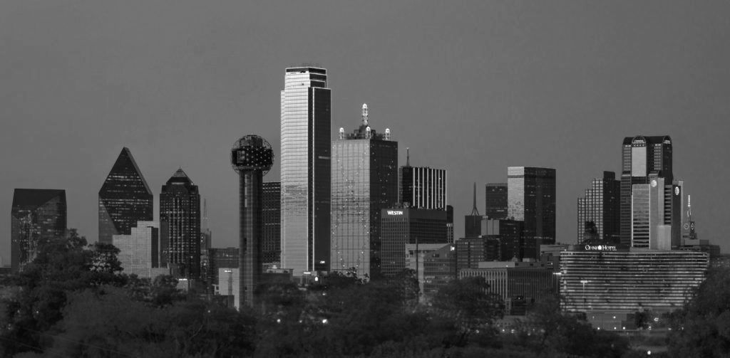 A black and white photo of a city skyline at night
