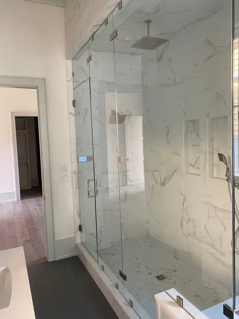 A bathroom with a walk-in shower and a sink