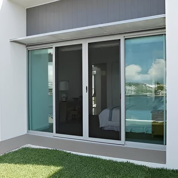 A Large Sliding Glass Door Opens To A Bedroom — Cessnock Glass in Port Stephens, NSW