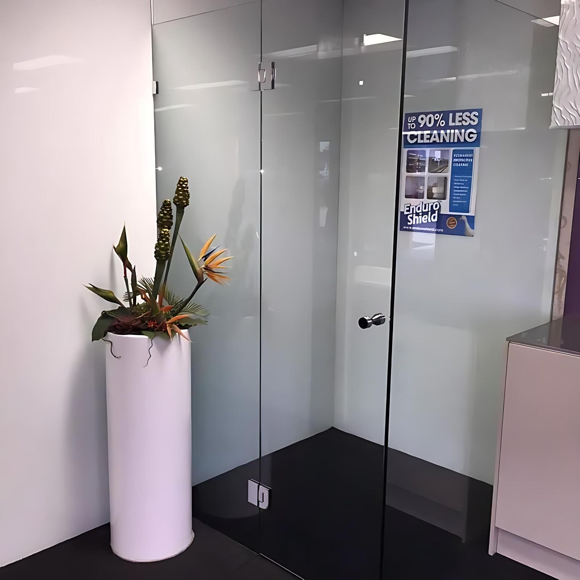 A Room With a Sign That Says E90 % Less Cleaning — Cessnock Glass in Cessnock, NSW