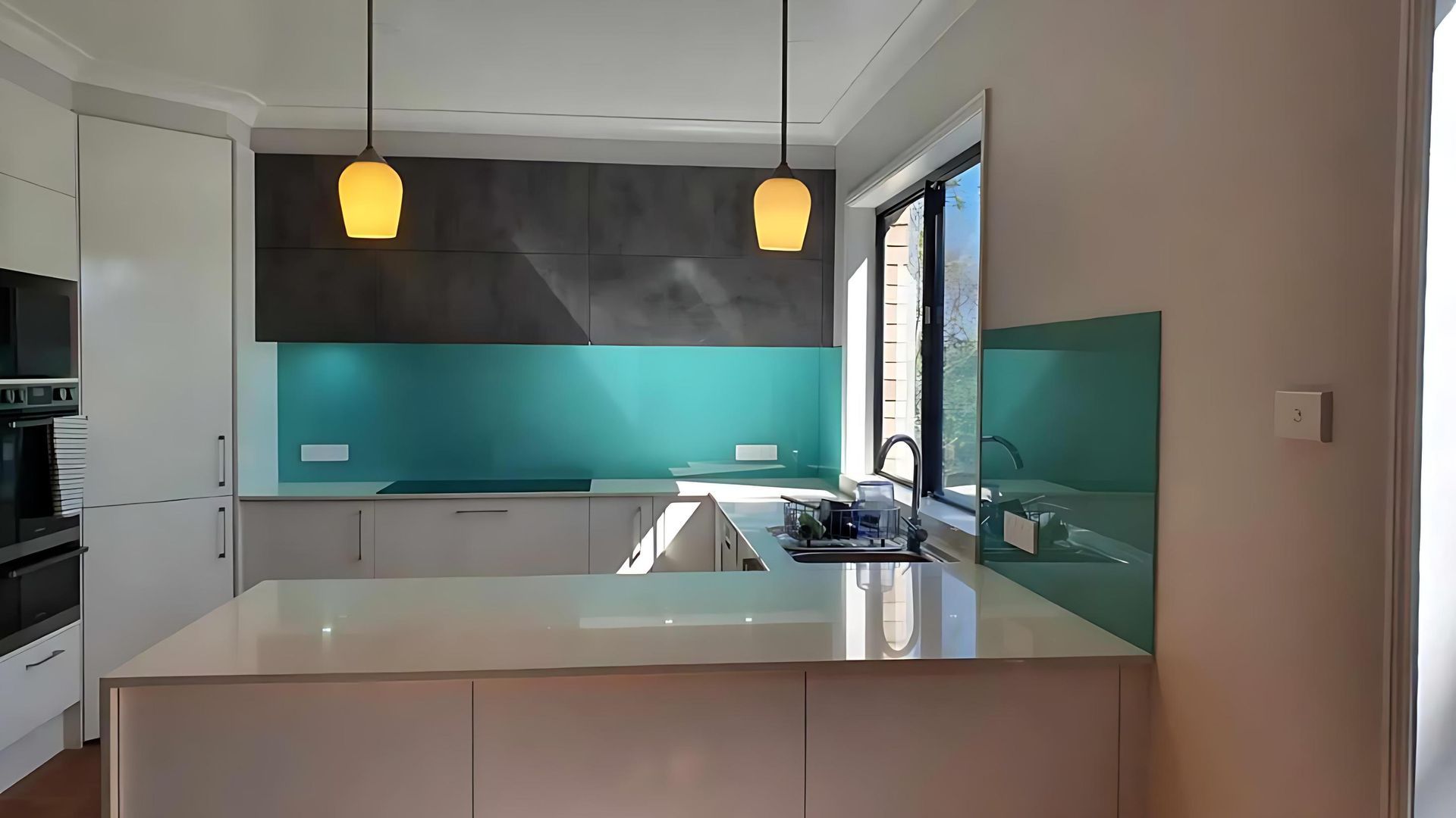 A Kitchen With White Cabinets and a Green Backsplash — Cessnock Glass in Cessnock, NSW