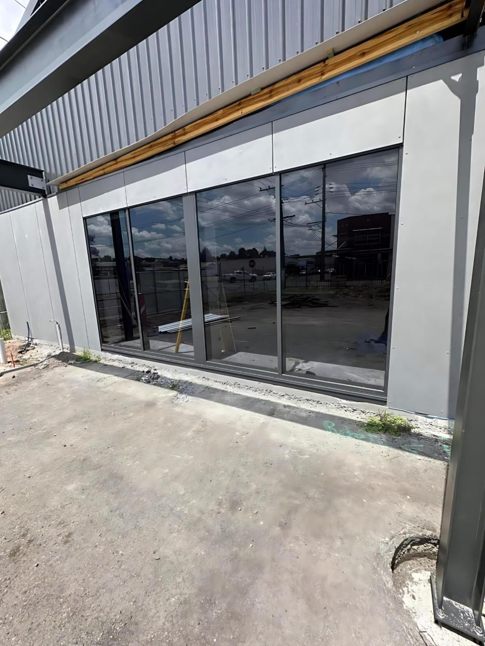 A Large Building With a Lot of Windows is Being Built — Cessnock Glass in Cessnock, NSW