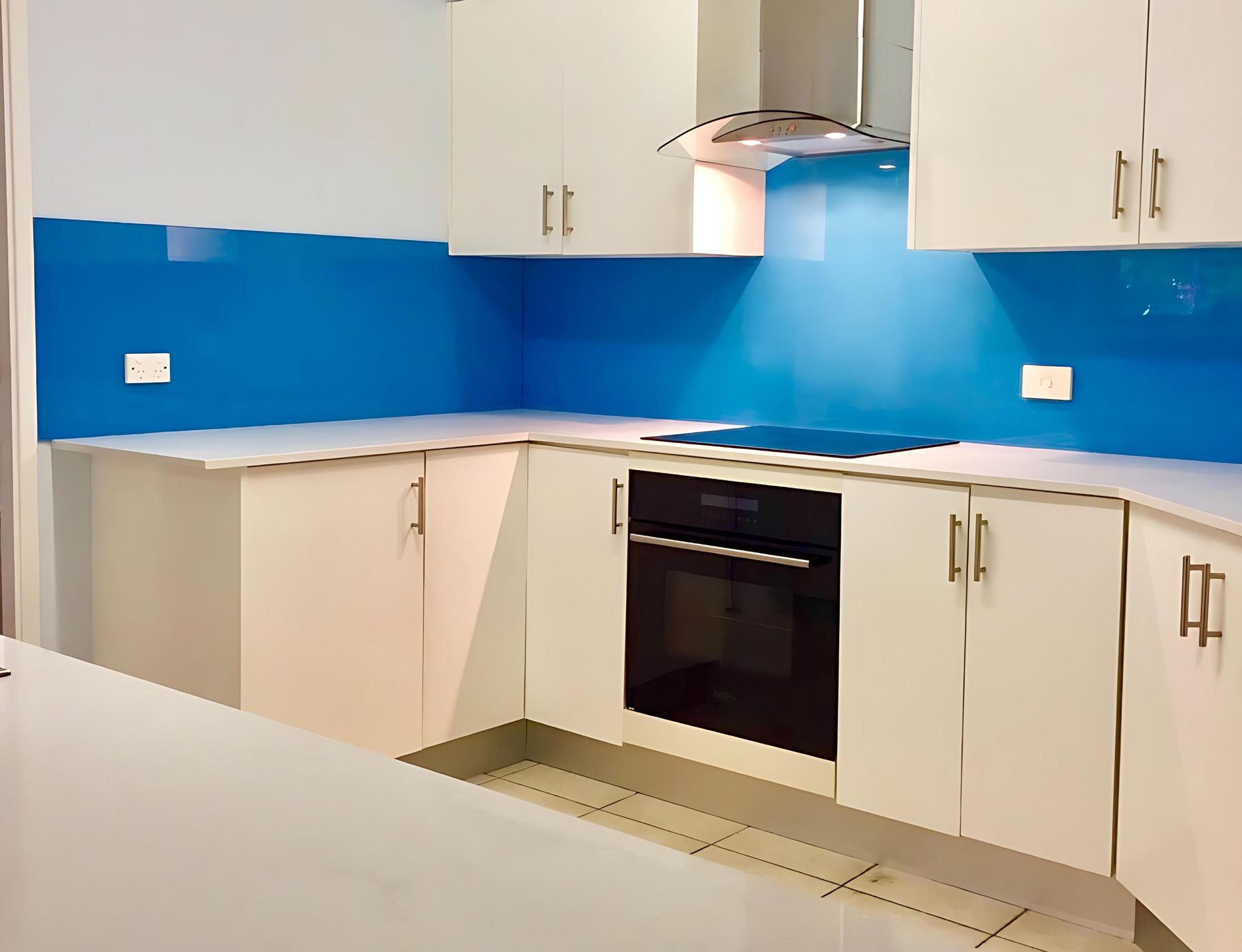 A Kitchen With White Cabinets and a Blue Backsplash — Cessnock Glass in Cessnock, NSW