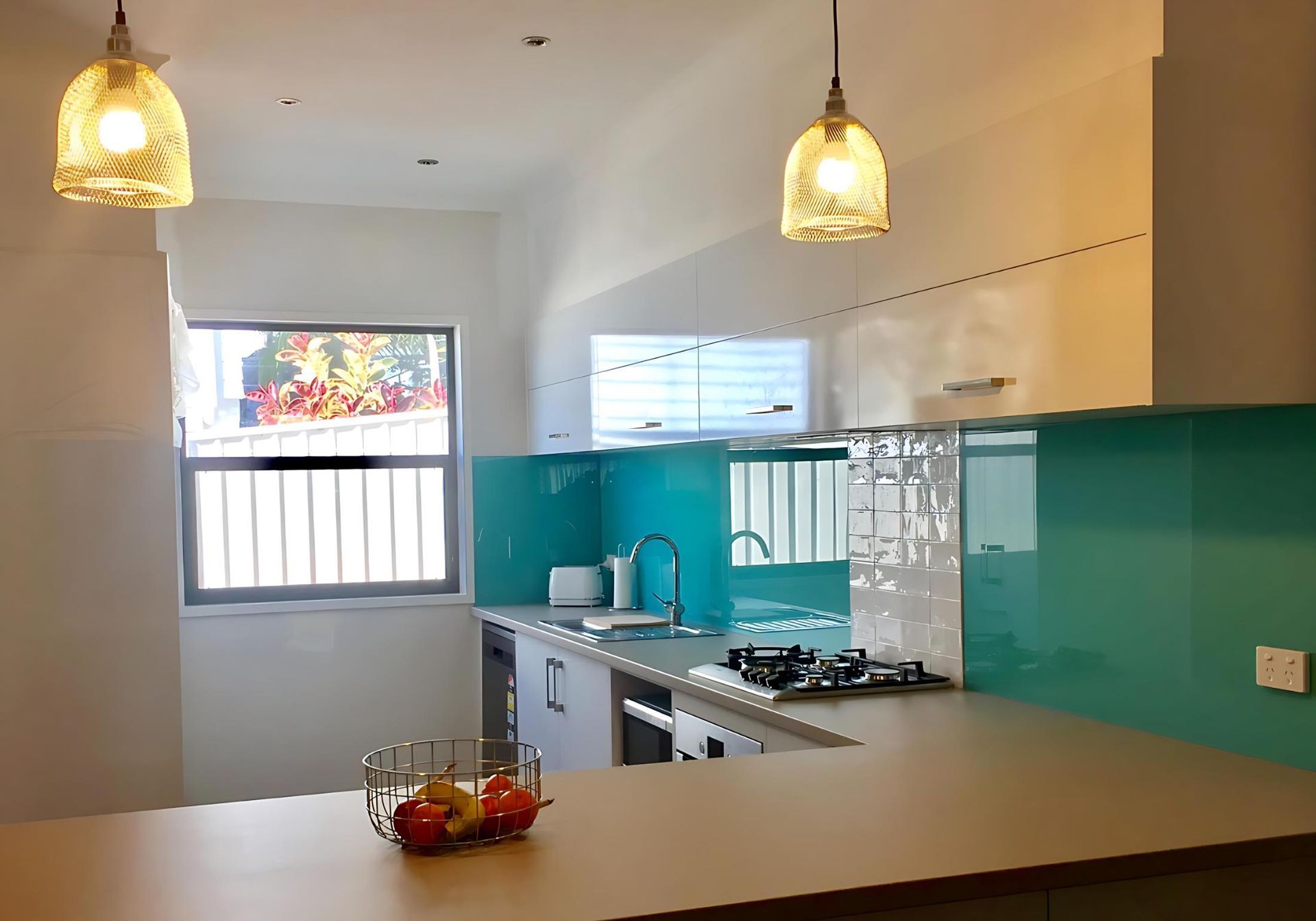 A Kitchen With White Cabinets and a Blue Counter Top — Cessnock Glass in Cessnock, NSW