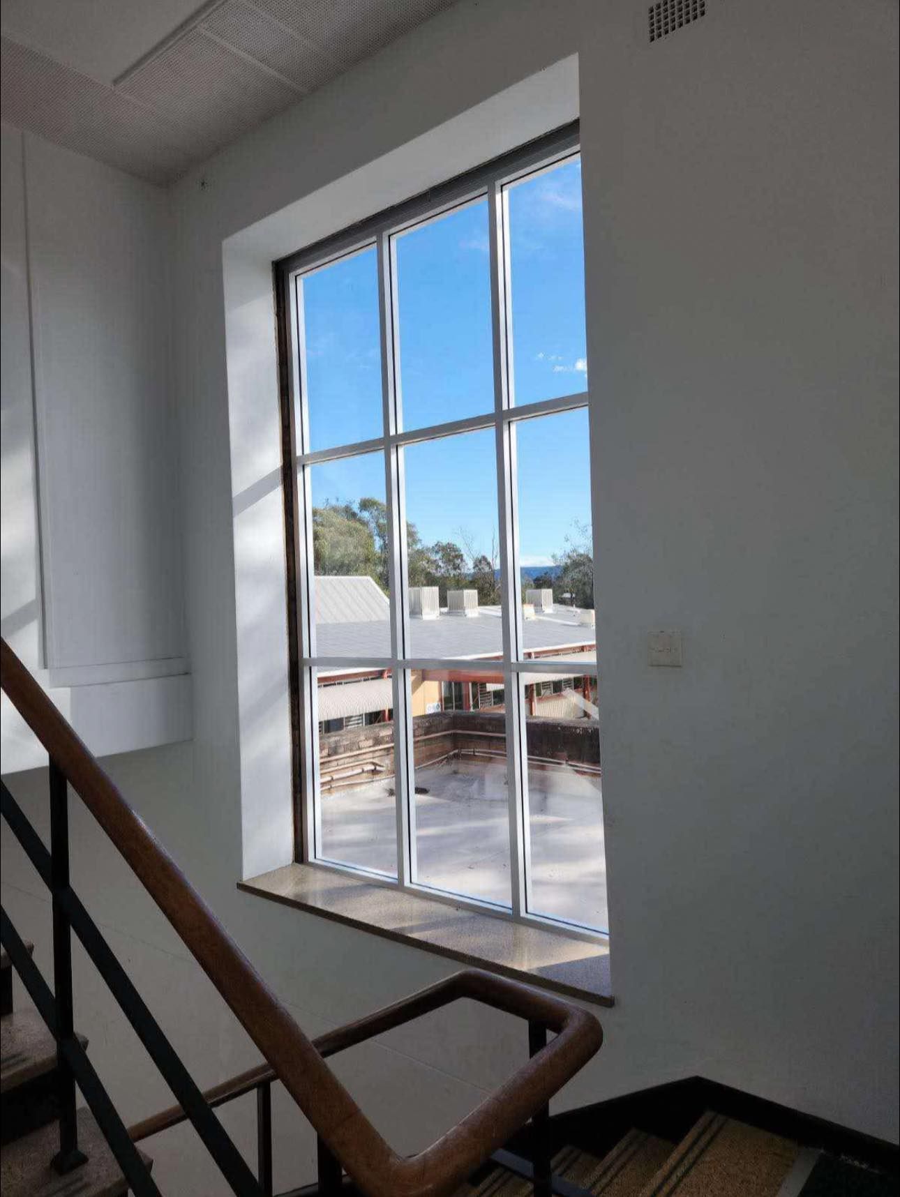 White Window Over Staircase Roof And Trees