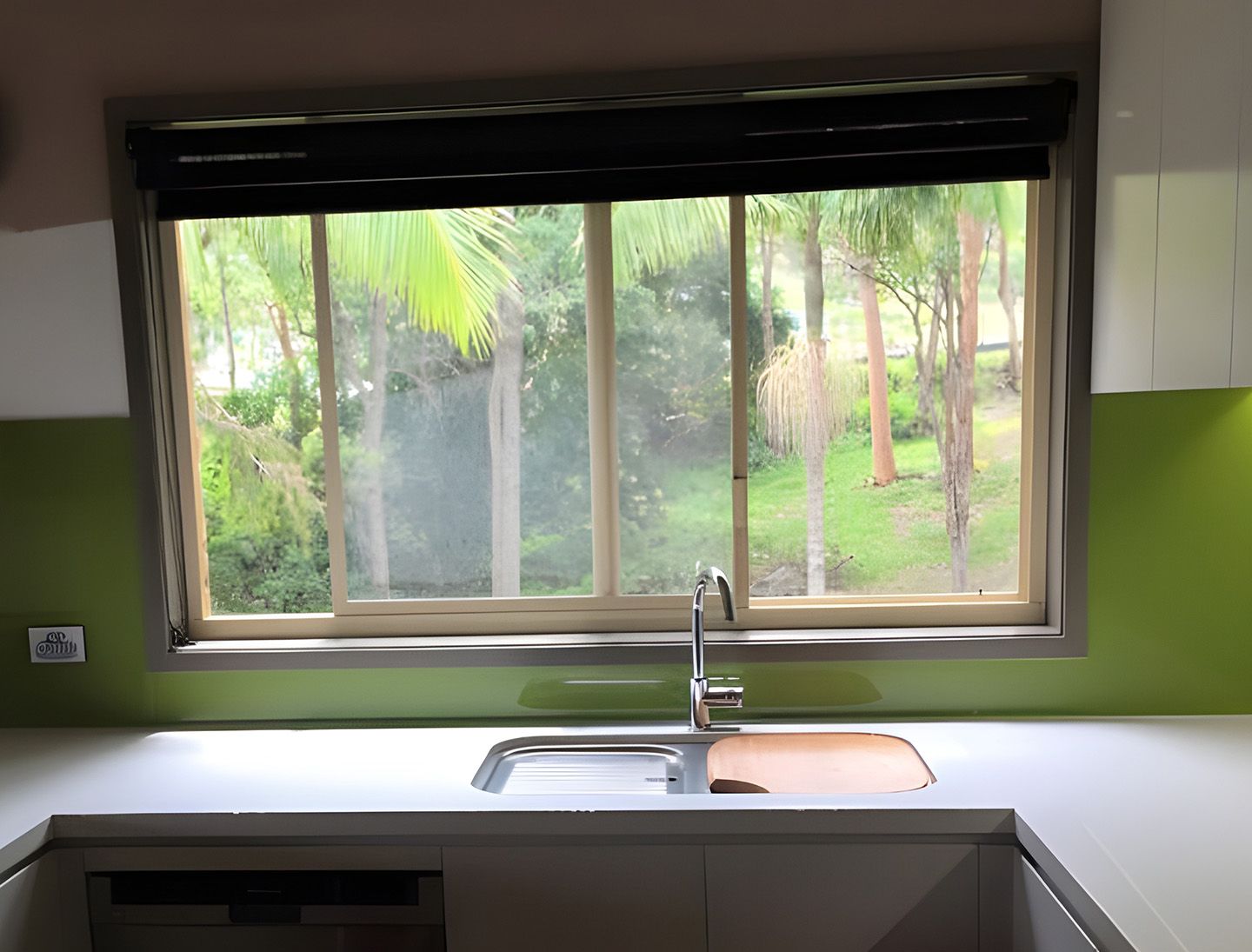 Modern Kitchen Sink Beneath A Wide Glass Window