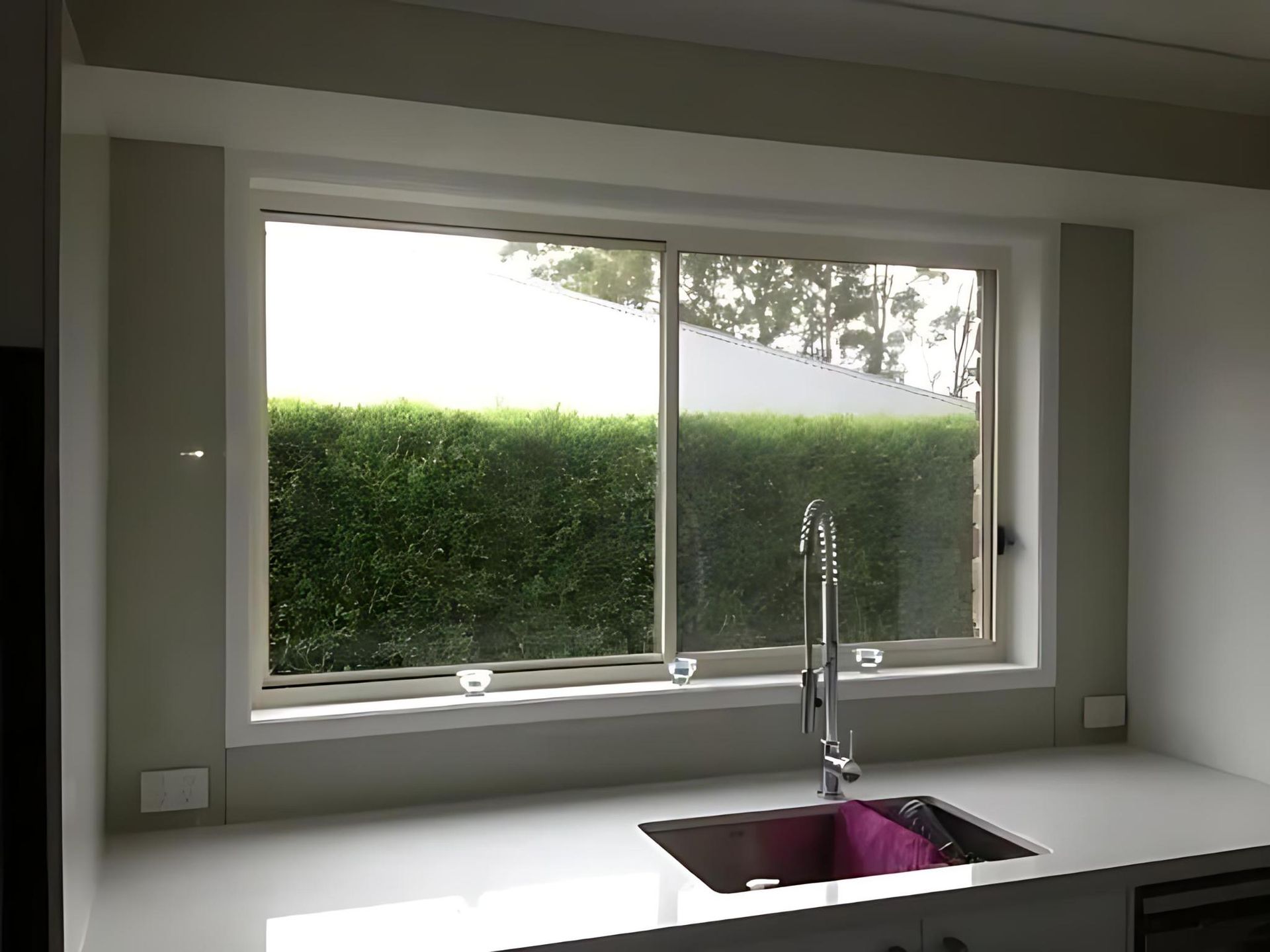 A Kitchen With a Sink and a Large Window — Cessnock Glass in Lake Macquarie, NSW