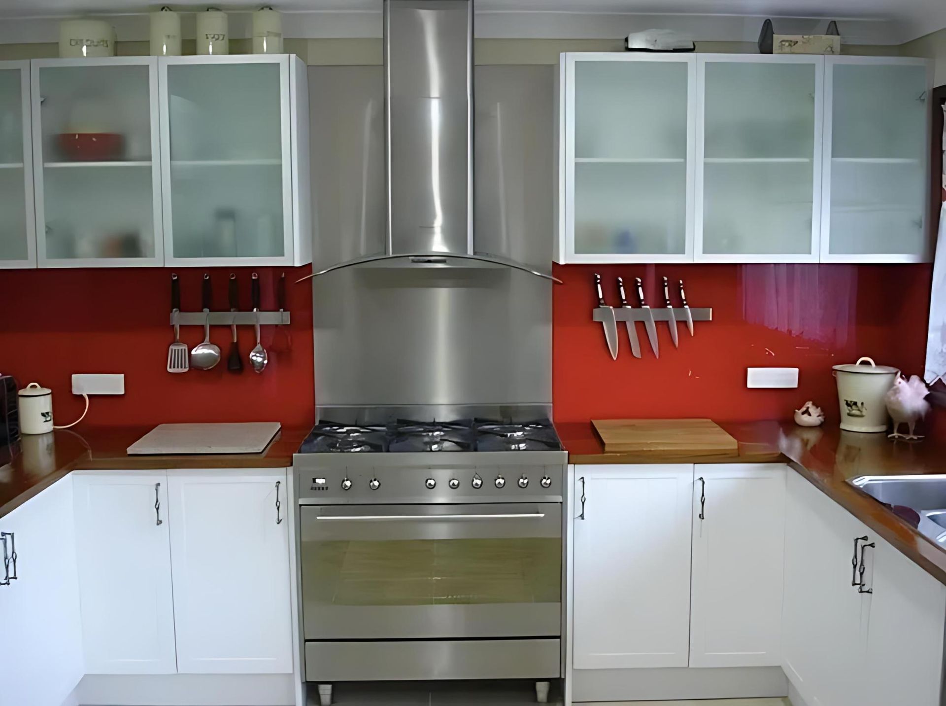 A Kitchen With Stainless Steel Appliances and White Cabinets — Cessnock Glass in Lake Macquarie, NSW