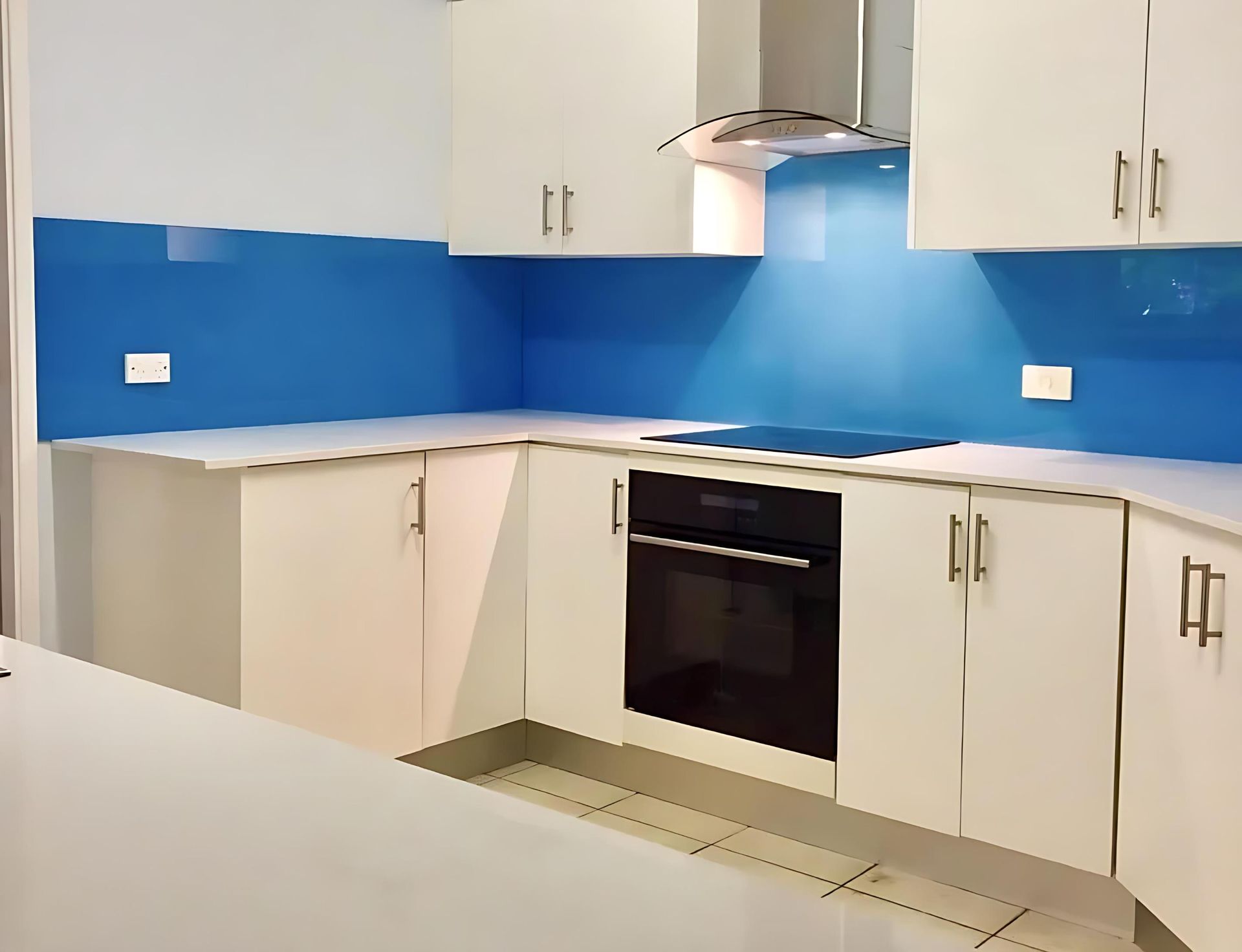 A Kitchen With White Cabinets and a Blue Backsplash — Cessnock Glass in Hunter Valley, NSW