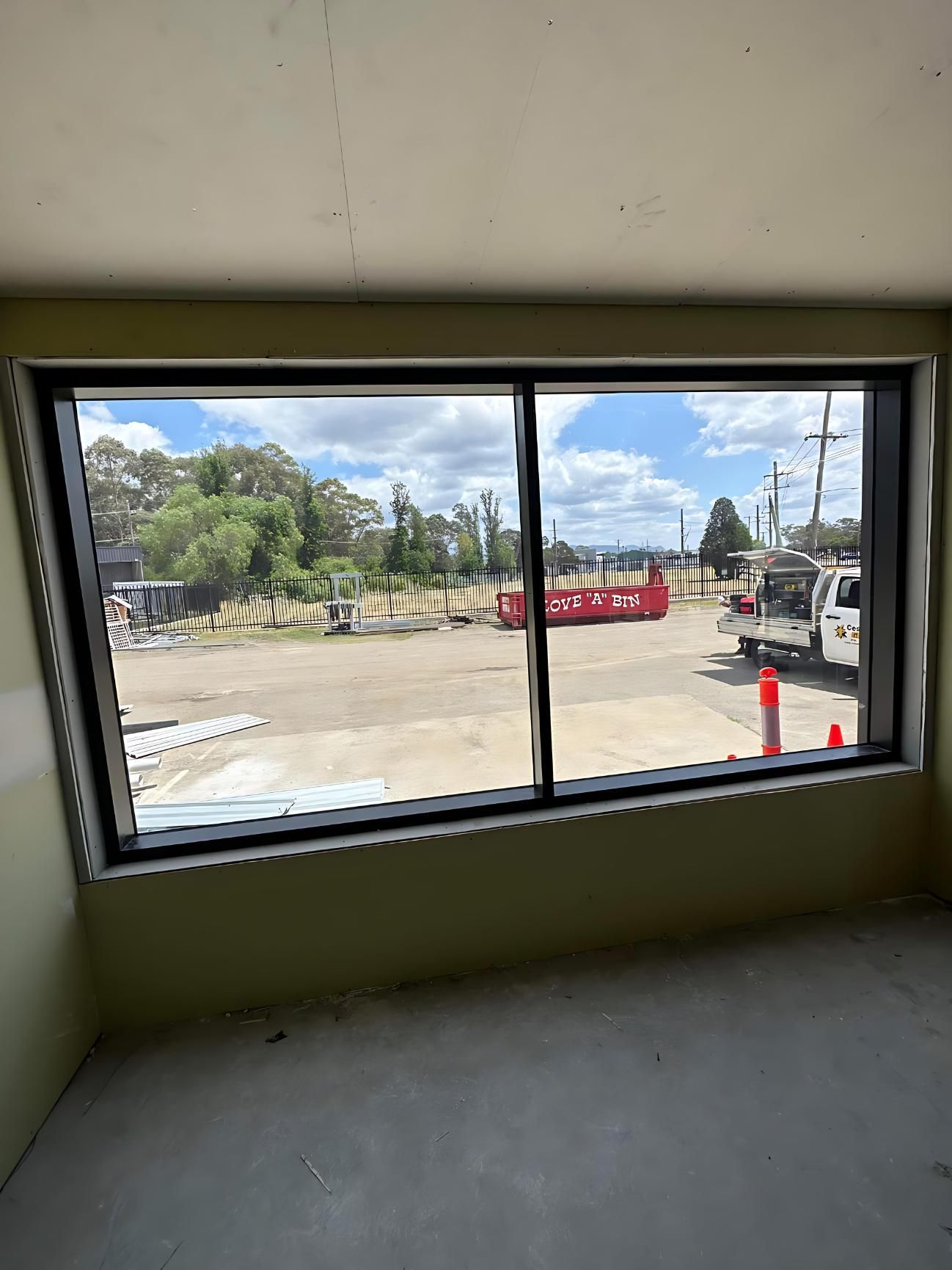 A Large Window in a Room With a View of a Parking Lot — Cessnock Glass in Newcastle, NSW