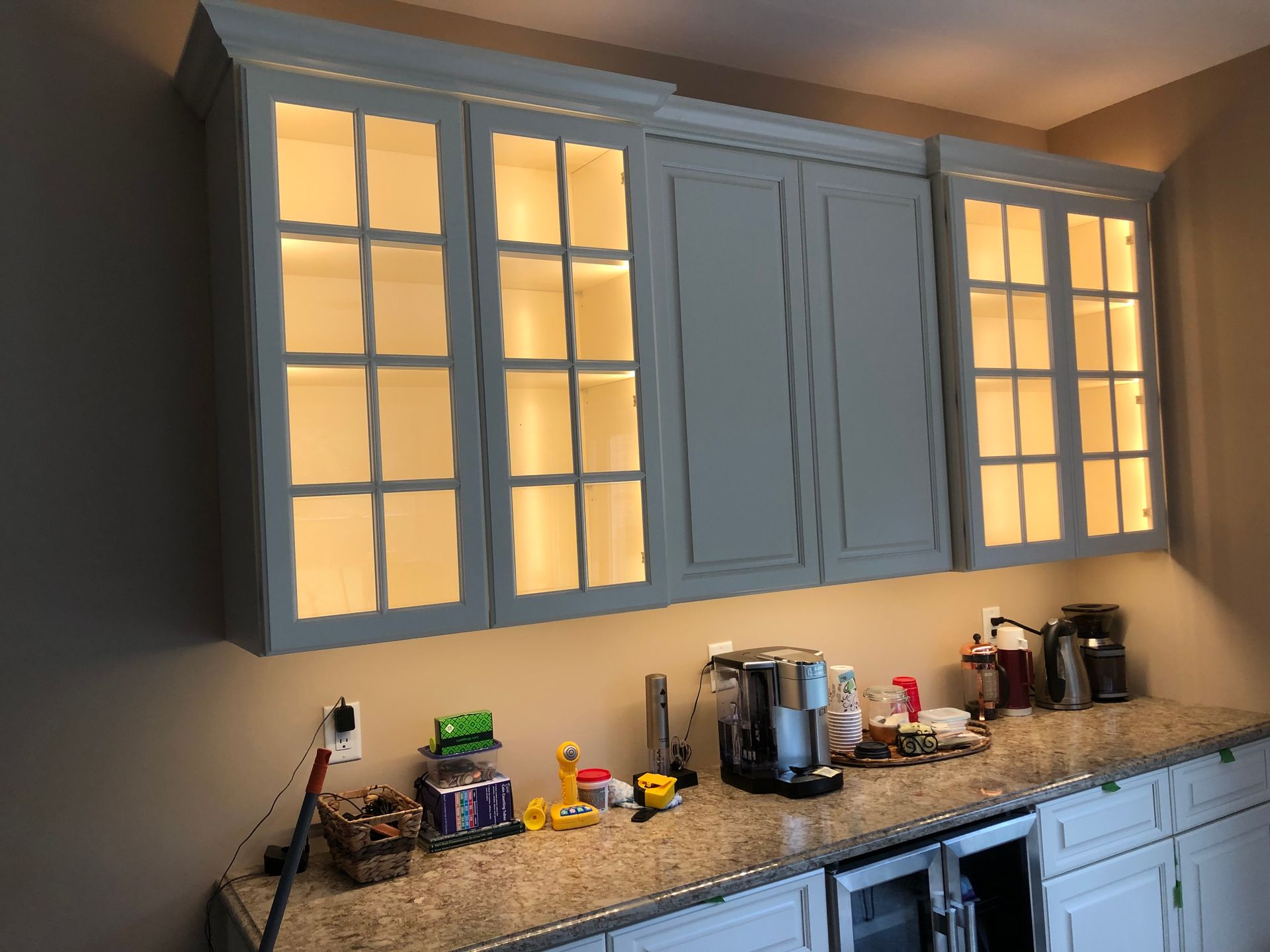 A kitchen with white cabinets and a granite counter top.