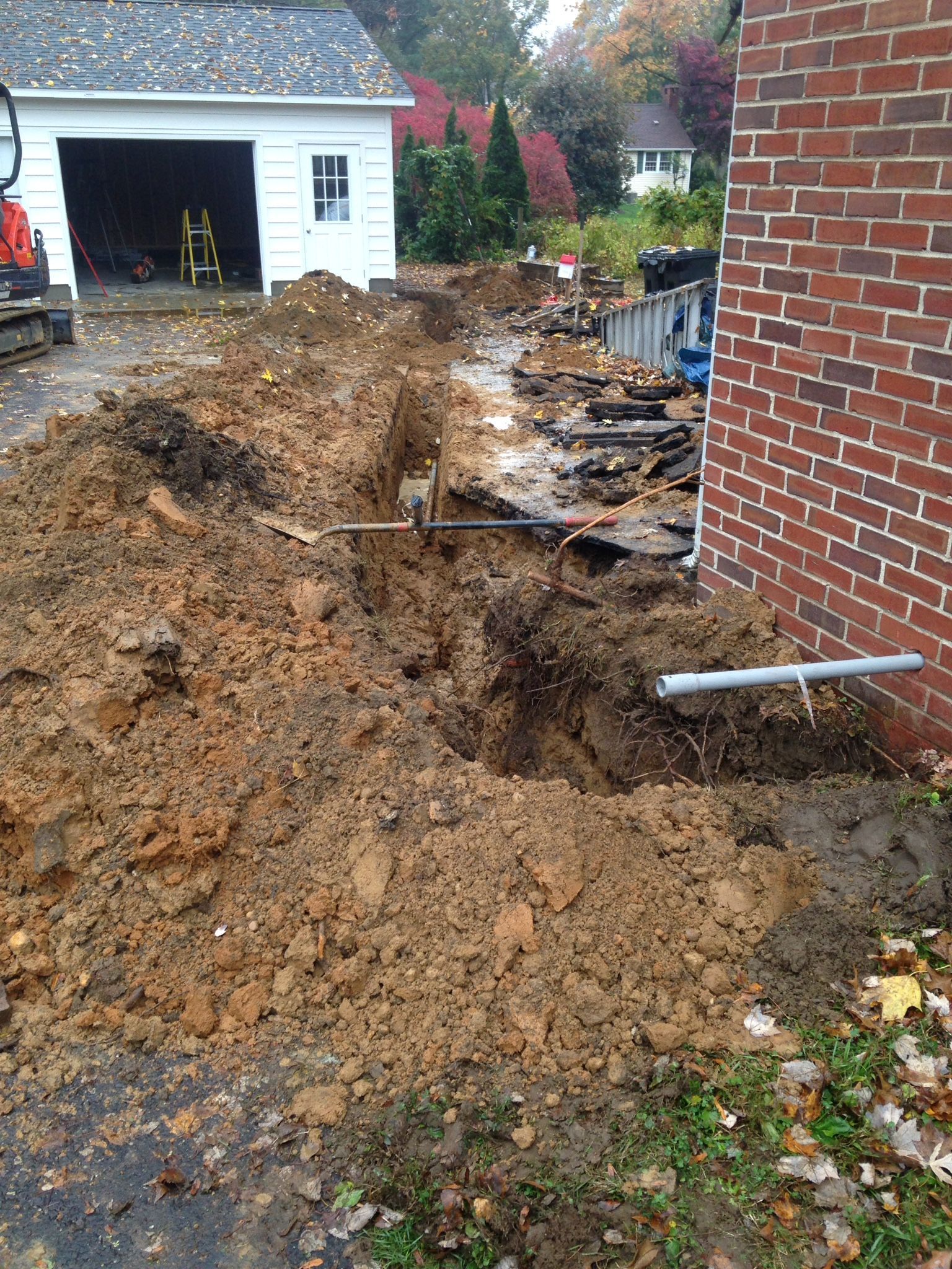 A pile of dirt is sitting in front of a brick building.