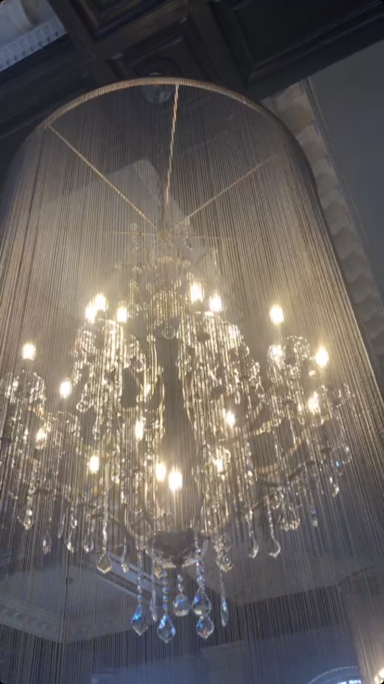 A large chandelier is hanging from the ceiling in a room.